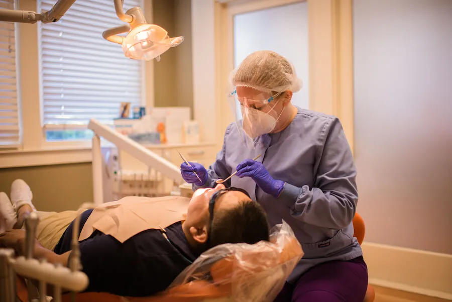 A hygienist carrying out a dental cleaning